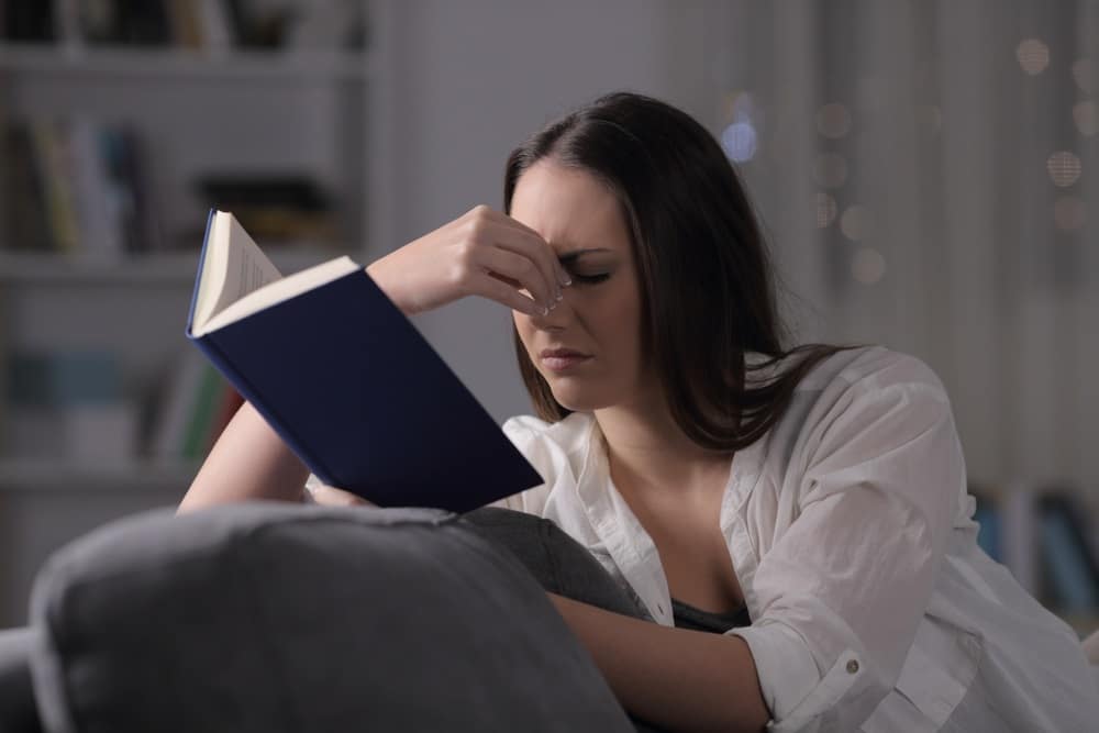 Woman reading with eyestrain